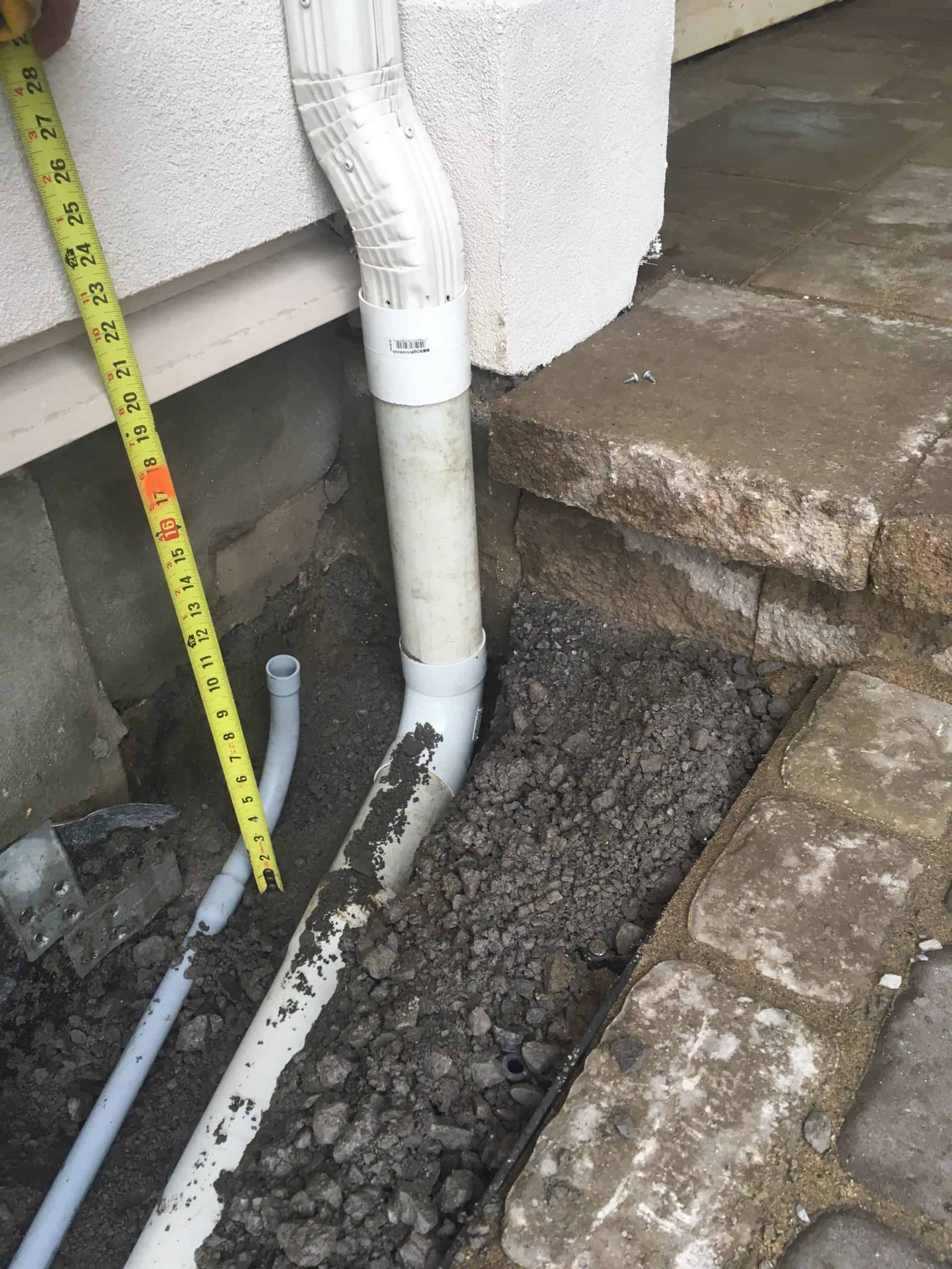 Landscape drainage work beside an interlock area